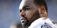 In this Nov. 25, 2012 photo, Baltimore Ravens tackle Michael Oher sits on the sidelines during the second half of an NFL football game against the San Diego Chargers, in San Diego. Oher and his adoptive family were depicted in the book and movie, "The Blind Side." Oher will play in his first Super Bowl on Sunday, Feb. 3, 2013, in New Orleans, which is where his adoptive father grew up and went to high school with author Michael Lewis, who wrote "The Blind Side." (AP Photo/Gregory Bull)